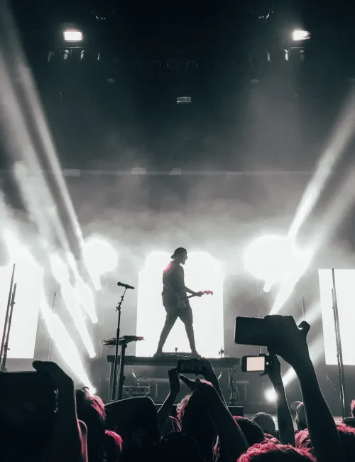 silhouette-photo-of-man-standing-on-stage-3379264